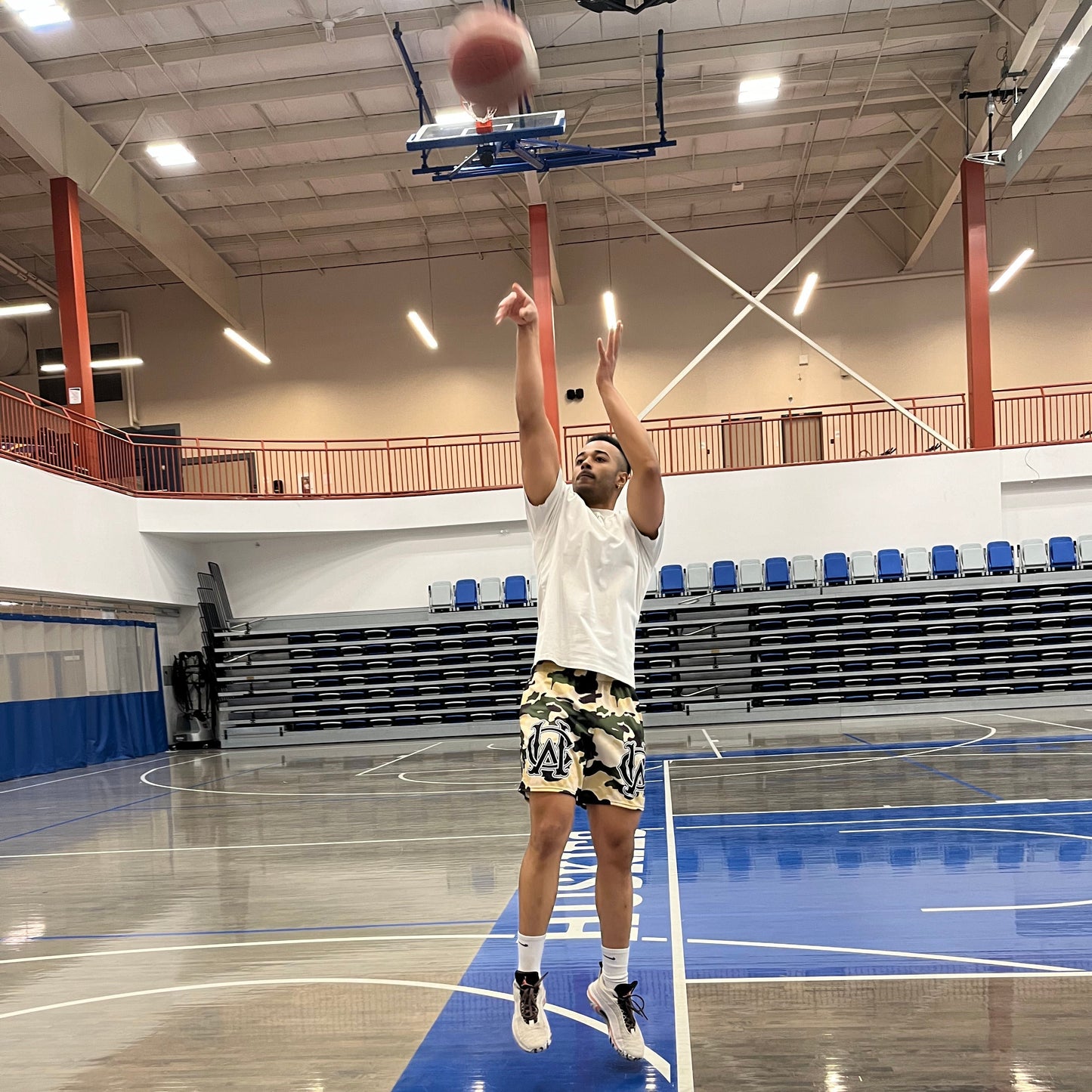 Model wearing Wolves Cry Originals OG Mesh Shorts Cream Camo “Desert Hunter” Edition on the basketball court, blending performance and bold style.