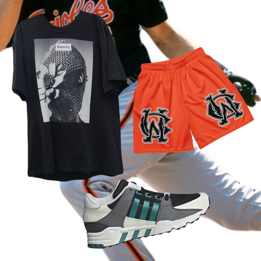 Close-up detail of Wolves Cry Originals OG Mesh Shorts “Iron Man Edition,” showcasing vibrant orange fabric, bold monogram design, and precise stitching.