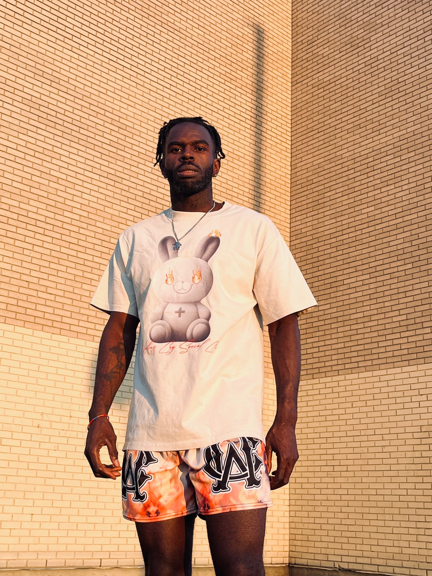 Close-up of the Wolves Cry Oversized Teddy Tee graphic, highlighting the teddy in flames with vibrant detailing and text design.