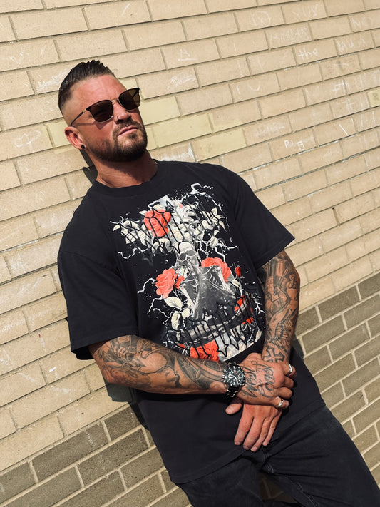 Close-up of Wolves Cry Prayer Tee art—skeleton in prayer, red roses, and gothic text on heavyweight cotton tee.