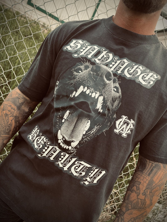 Detail of Wolves Cry Savage Beauty Tee with gothic lettering and roaring wolf graphic on charcoal fabric