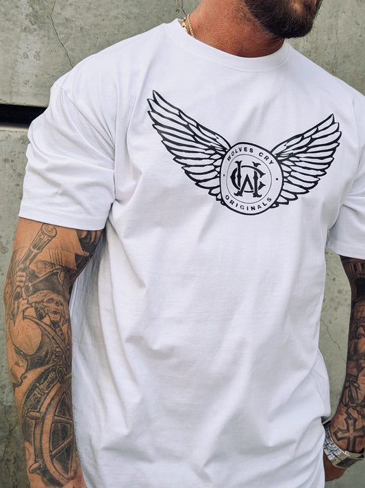 Close-up of WC Flight Academy Tee in white worn by model, showing bold winged crest logo detail.