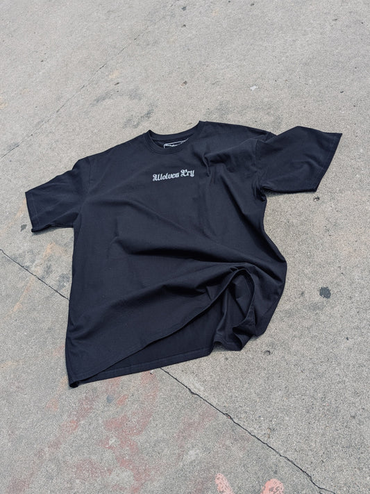 WC Shadow Floral Tee front flat lay on concrete — minimal gothic logo, oversized fit