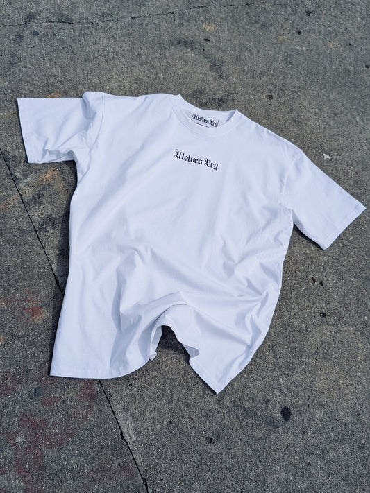 WC Shadow Floral Tee in white — front flat lay on concrete with gothic Wolves Cry logo