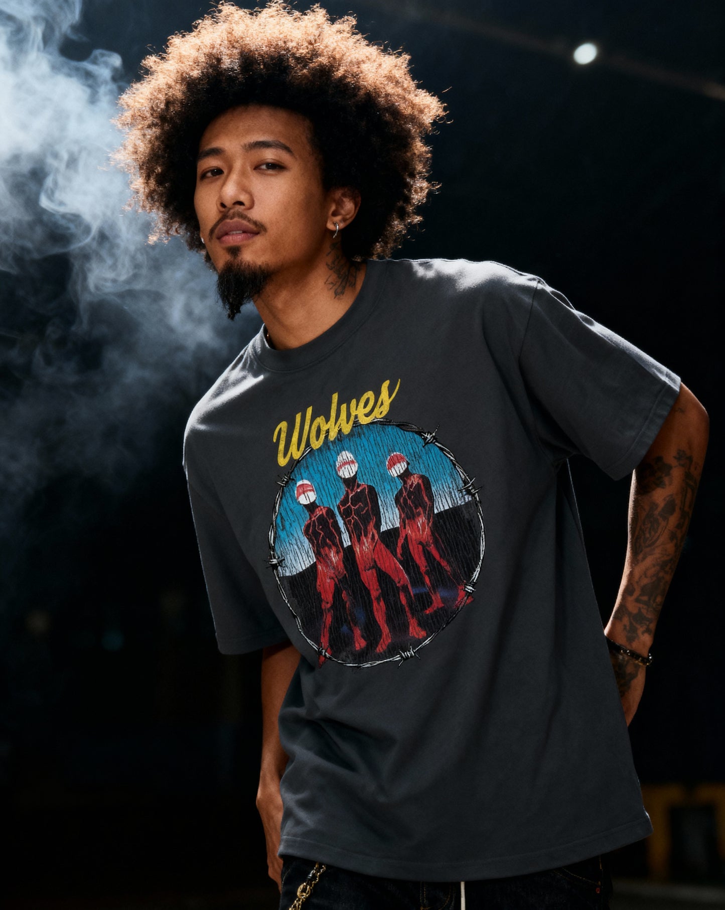 Side profile of model in Wolves Cry Descendants vintage black tee — soft washed cotton with distressed band-era graphic feel.