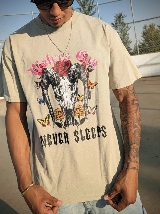 Model wearing Wolves Cry DVNS Tee in sage green — relaxed fit, desert-inspired palette, and vintage art energy for everyday streetwear expression.