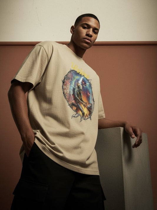 Model wearing the Wolves Cry Electric Symphony oversized tee in sand — warm tonal streetwear look with art-forward Wolves Cry storytelling.