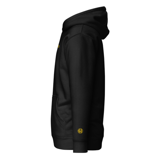 Side angle of black Wolves Cry Hoodie with yellow WC wrist monogram — iconic bold detail.