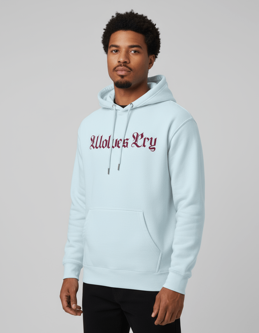 Man wearing a light blue hoodie with 'Wolves Cry' text on a gray background
