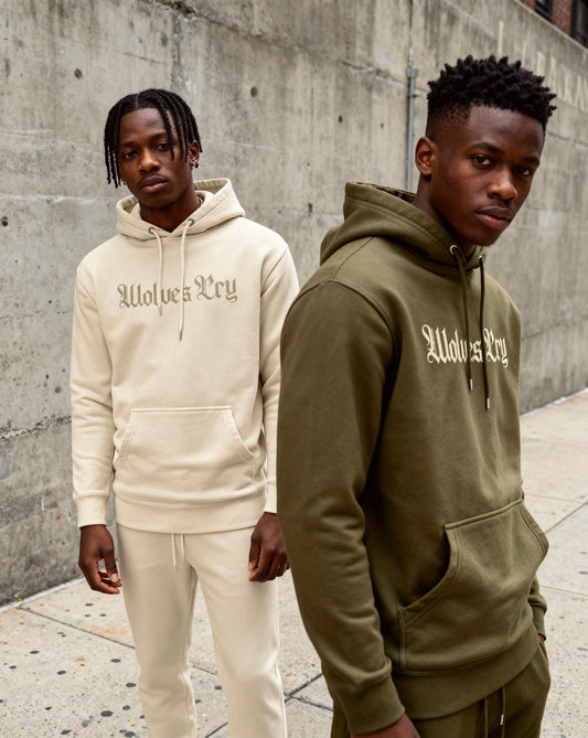 Models wearing Wolves Cry Everyday Spellout Hoodies in double oatmeal and forest green — contrasting tones that highlight everyday versatility.