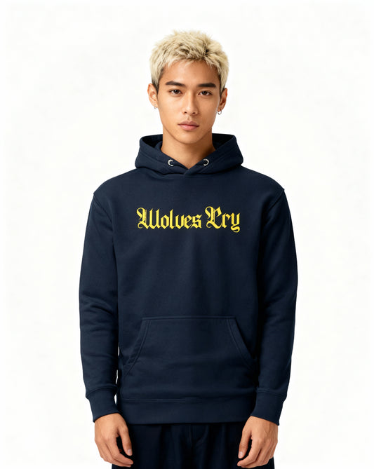 Studio shot of model wearing Wolves Cry navy hoodie with yellow spellout logo — balanced streetwear silhouette with confident stance.