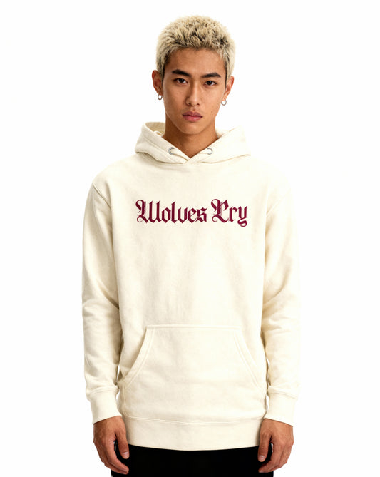 Close-up of Wolves Cry Everyday Spellout Hoodie showing merlot embroidery on soft oatmeal fabric — textured, balanced, and classic.