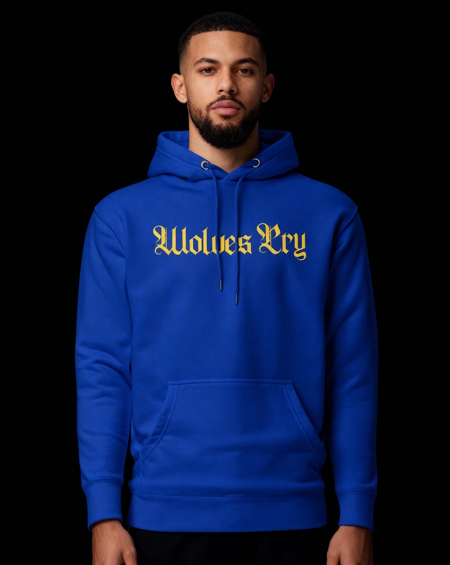 Royal blue Wolves Cry hoodie under low light — yellow gothic lettering pops with vintage athletic nostalgia and street edge.