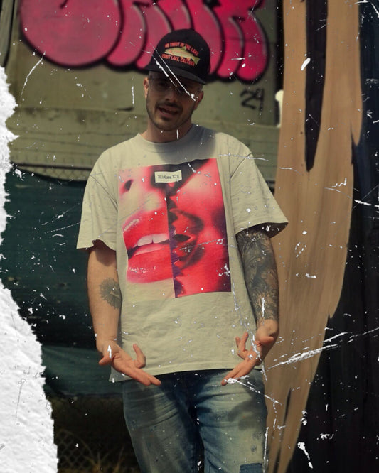 Wolves Cry Oversized Kiss Shirt styled in an urban setting, highlighting its relaxed fit and striking red-toned graphic for an effortlessly bold look.