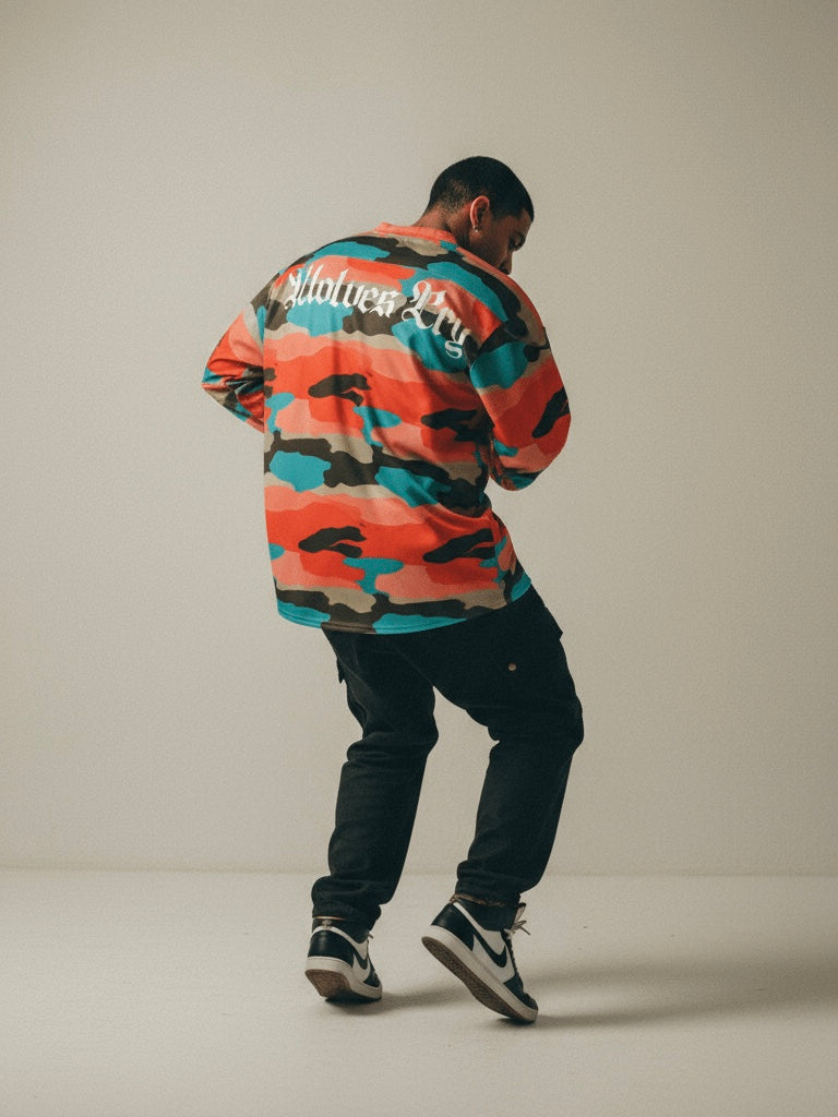 Model wearing a wolves cry originals camouflage jersey in motion, photographed against a neutral backdrop- symbolizing movement, individuality, and strength 