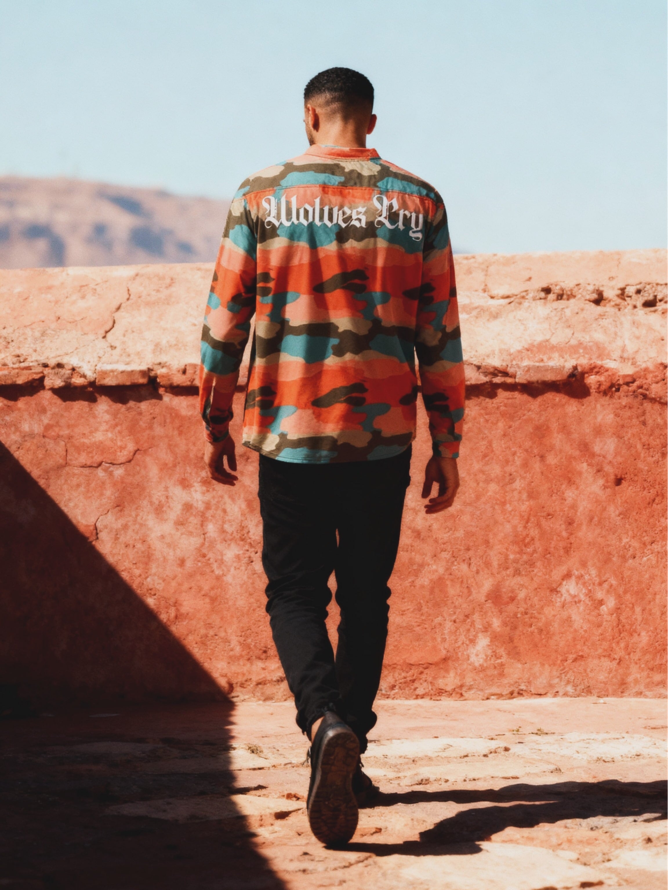 Model wearing a wolves cry originals hockey jersey through Marrakech rooftop view
