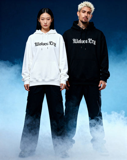 Two models wearing wolves cry originals hoodies in white and black, standing against a blue gradient background- modern Canadian streetwear essentials 