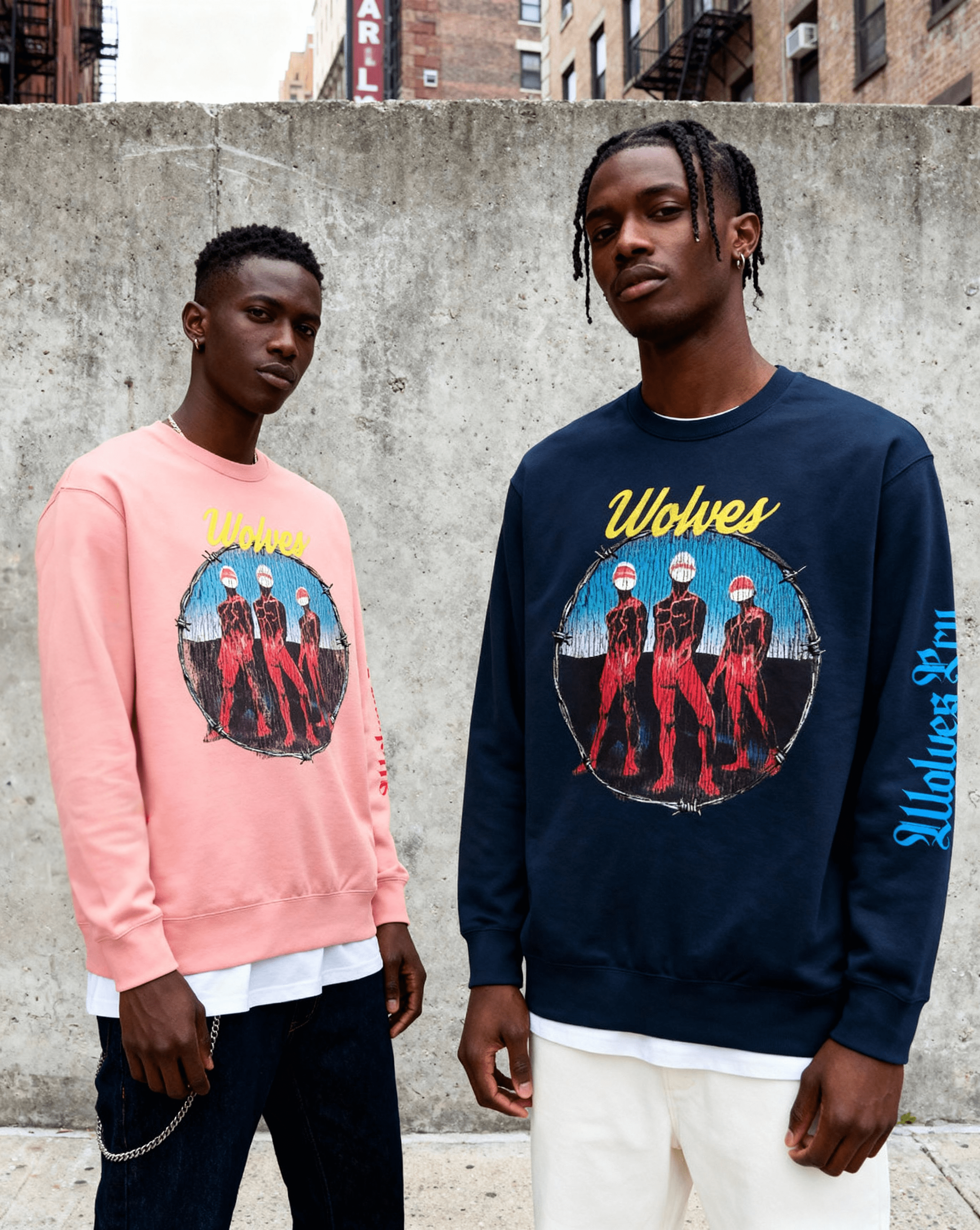 Two male models wearing sweatshirts with 'Wolves cry originals branding graphic for the code section against a concrete wall. Streetwear modern vintage 
