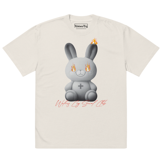 Front view of Wolves Cry Originals Oversized Teddy Tee in bone off-white, featuring a bold graphic of a teddy bear engulfed in flames, symbolizing resilience and nostalgia.