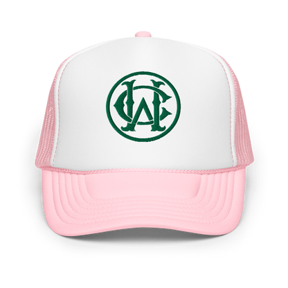 Wolves Cry “The Retirement” Foam Trucker Hat with a white foam front, soft pink brim, and green embroidered Wolves Cry monogram logo, evoking playful Miami-inspired vibes.