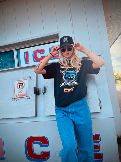 Model in Wolves Cry Thundercat Electro Tee and logo cap, showcasing relaxed oversized streetwear fit with retro graphic style and washed finish