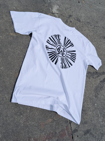 White graphic tee with full circular “About Cause Not Applause” print on back, street-style lay flat