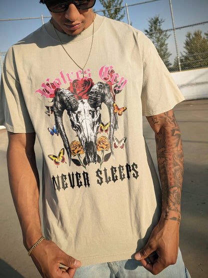 Model wearing Wolves Cry DVNS Tee in sage green — relaxed fit, desert-inspired palette, and vintage art energy for everyday streetwear expression.