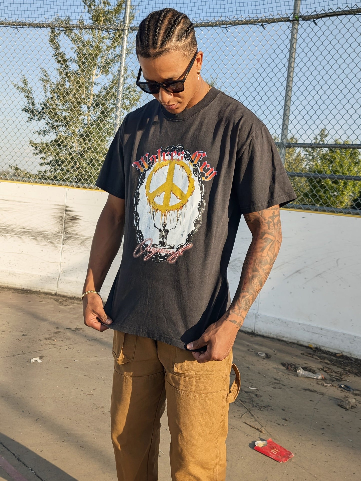 Model wearing Wolves Cry Endless Peace Tee in black vintage — faded tone, oversized cut, and rebellious energy captured through bold graphic detail.