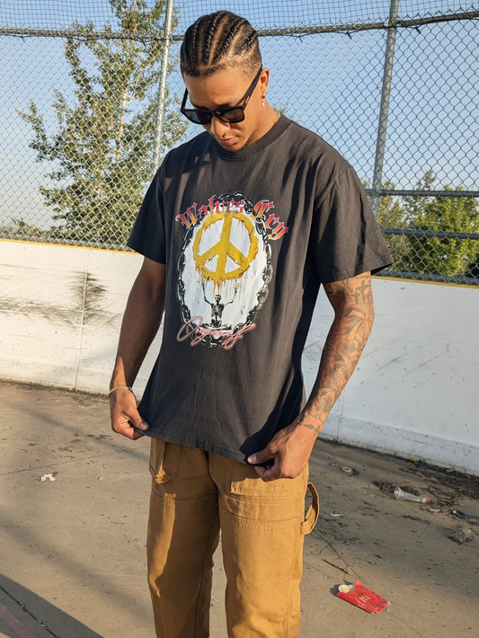 Model wearing Wolves Cry Endless Peace Tee in black vintage — faded tone, oversized cut, and rebellious energy captured through bold graphic detail.
