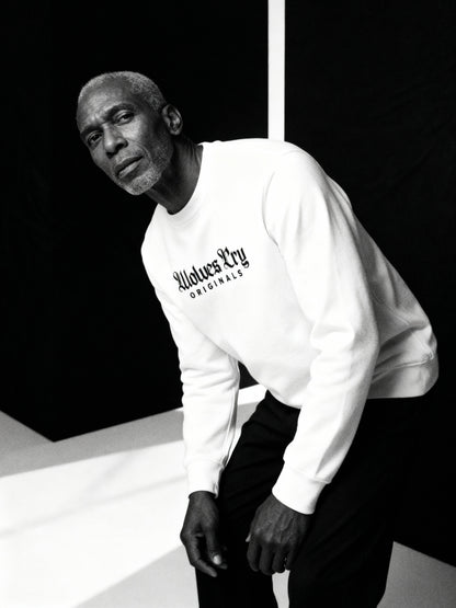 Wolves Cry Embroidered Plain Jane Crew in white captured mid-motion — showcasing effortless confidence and everyday luxury.