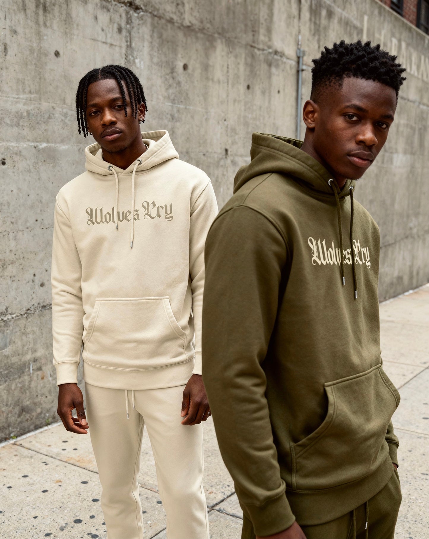 Models wearing Wolves Cry Everyday Spellout Hoodies in double oatmeal and forest green — contrasting tones that highlight everyday versatility.
