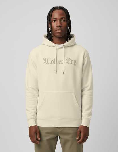 Studio shot of model wearing Wolves Cry Everyday Spellout Hoodie in double oatmeal — relaxed fit, subtle tone-on-tone logo for a refined streetwear look.