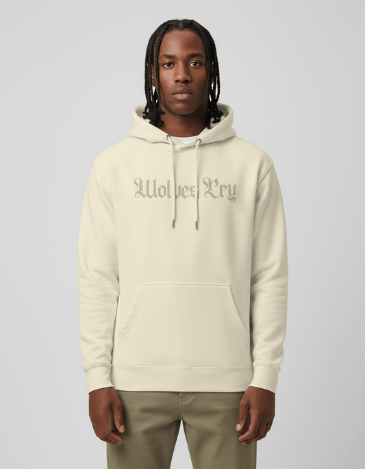 Studio shot of model wearing Wolves Cry Everyday Spellout Hoodie in double oatmeal — relaxed fit, subtle tone-on-tone logo for a refined streetwear look.