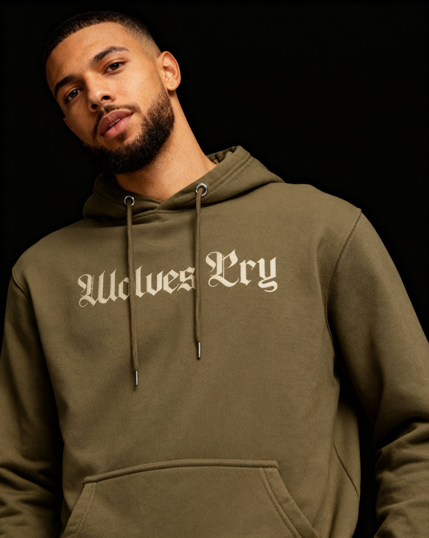 Close-up of Wolves Cry Everyday Spellout Hoodie in double olive — textured fabric and tonal stitching emphasizing craftsmanship and durability.