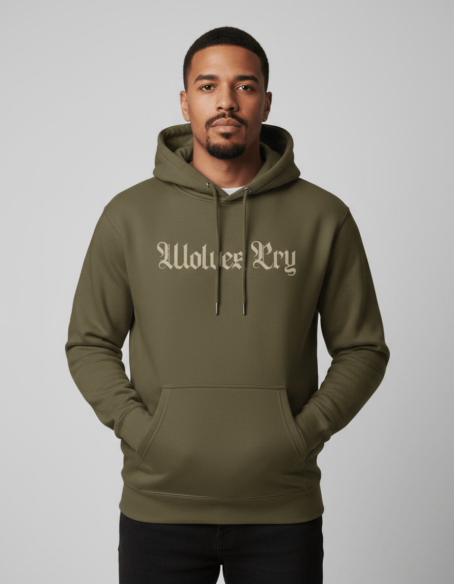 Studio shot of model wearing Wolves Cry Everyday Spellout Hoodie in double olive — relaxed fit with subtle gothic embroidery across the chest.