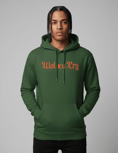 Model wearing Wolves Cry Everyday Spellout Hoodie in forest green with orange embroidery — blending athletic confidence with bold street energy.