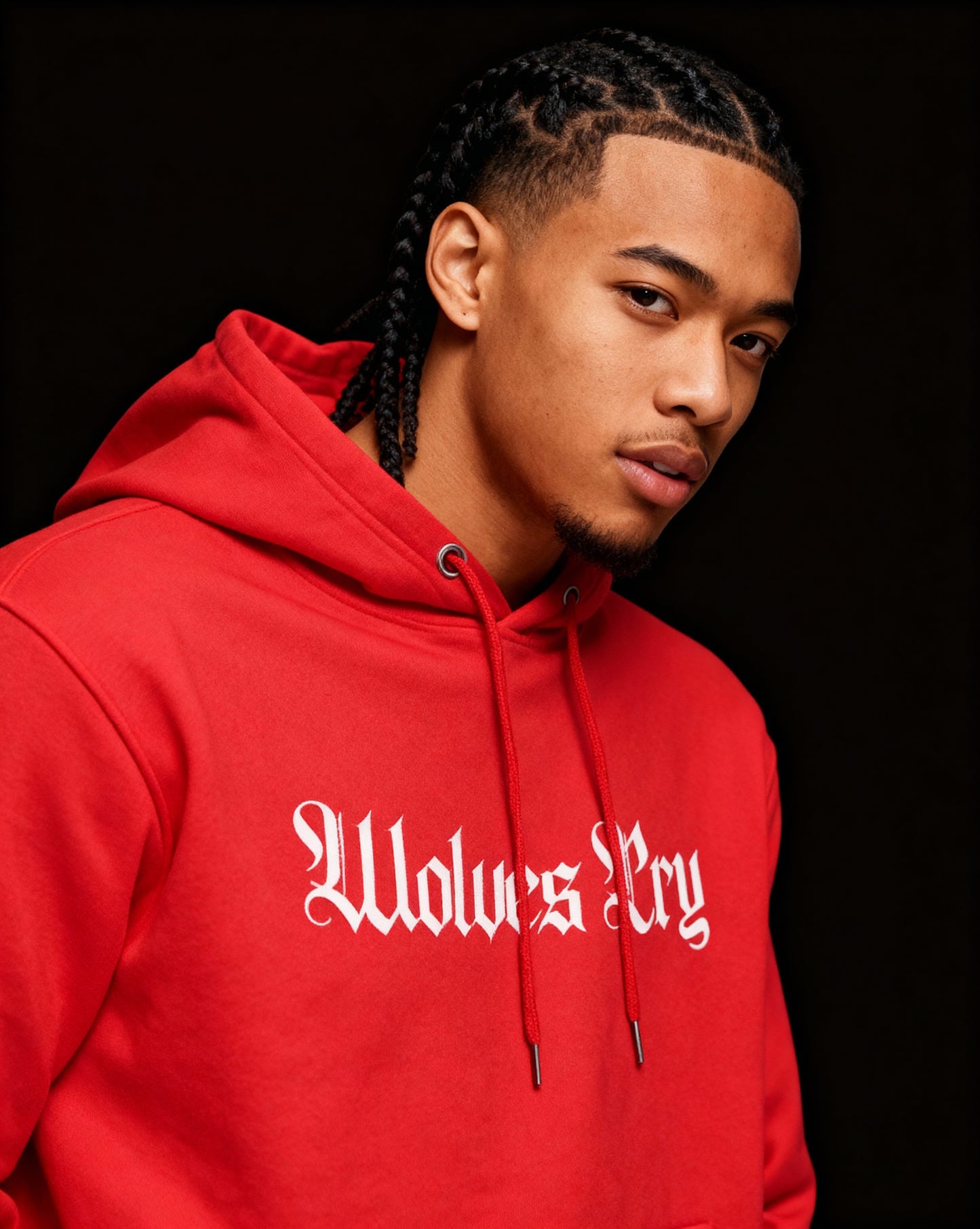 Close-up of Wolves Cry Everyday Spellout Hoodie showing white logo on vibrant red base, capturing premium texture and craftsmanship.