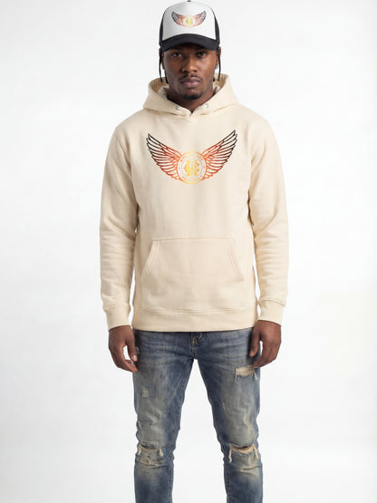 Man wearing a wolves cry beige hoodie with a logo and distressed jeans on a white background