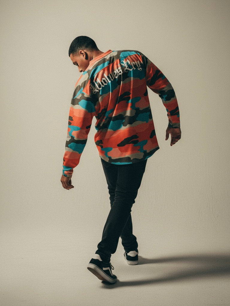 Model wearing Wolves Cry Marrakech Camo Jersey against Moroccan clay wall — inspired by desert tones and sunlit textures.