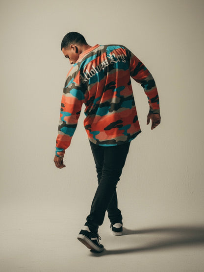 Model wearing Wolves Cry Marrakech Camo Jersey against Moroccan clay wall — inspired by desert tones and sunlit textures.