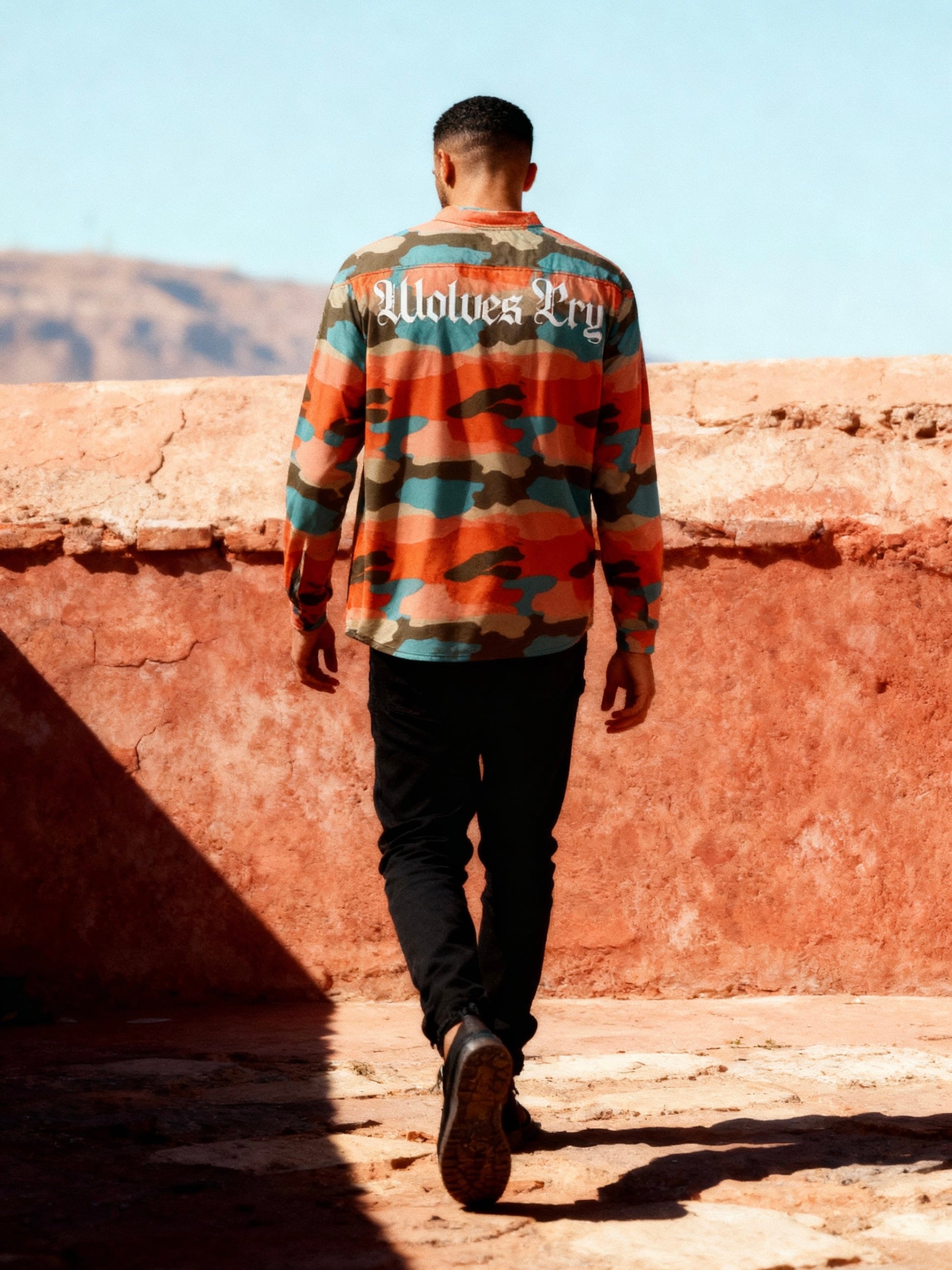 Side profile of Wolves Cry Marrakech Camo Jersey styled with black pants — casual streetwear with a bold camo aesthetic.
