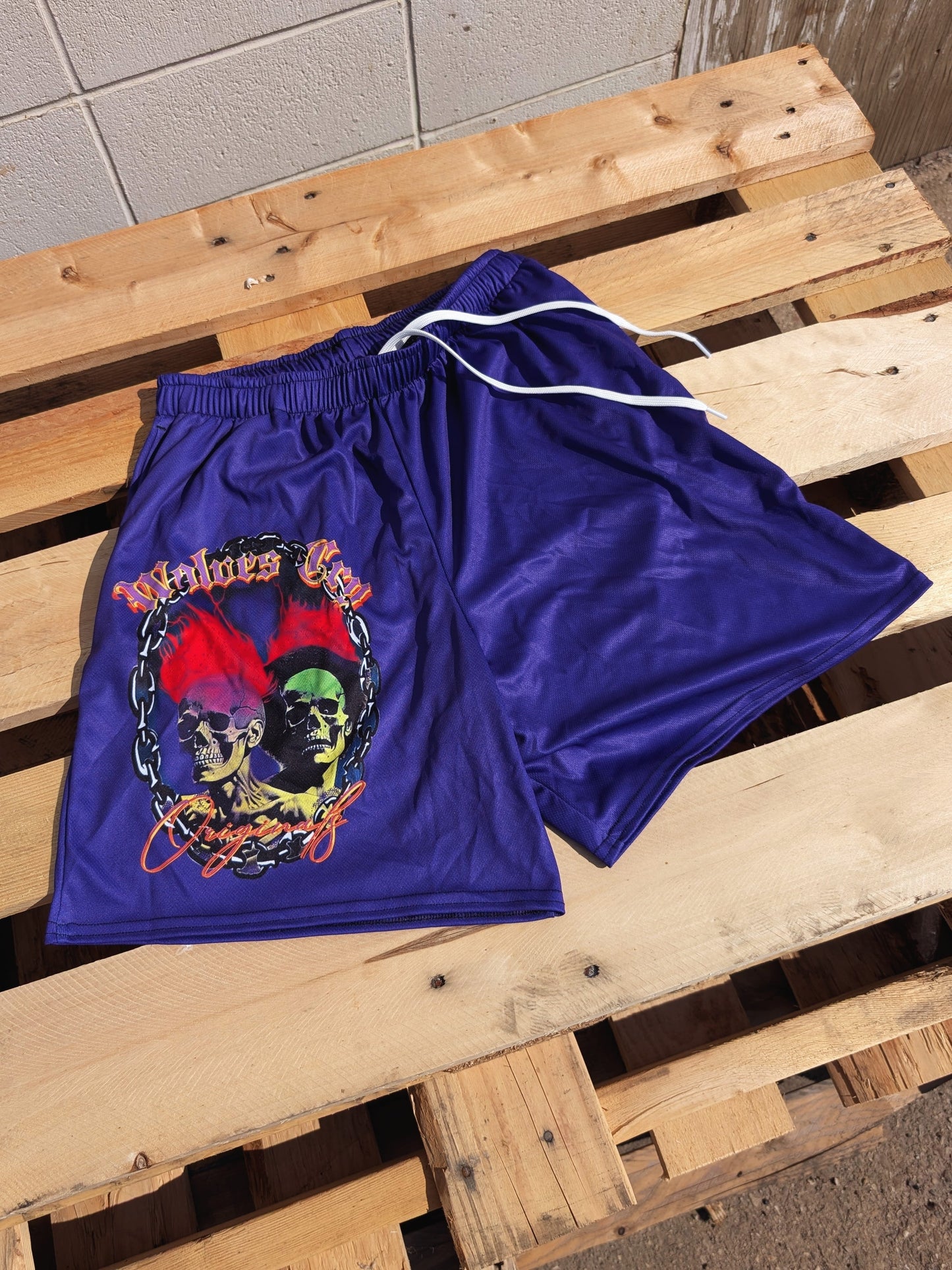 Flat lay of Wolves Cry Megadeath Mesh Shorts in Crown Purple — breathable mesh fabric with striking skull and flames artwork.