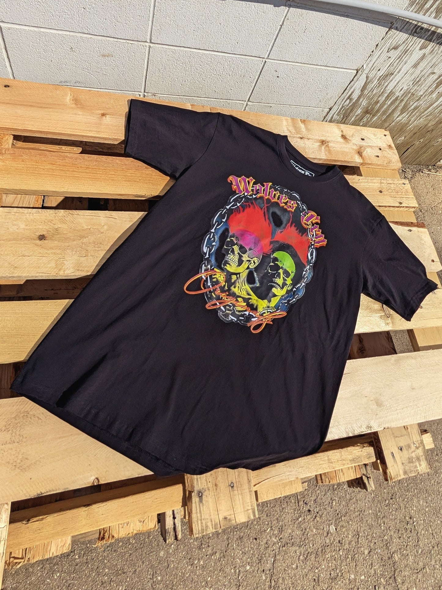 Flat lay of Wolves Cry Megadeath Tee in black, highlighting detailed front print featuring skull, roses, and Wolves Cry spellout — a mix of nostalgia and defiance.