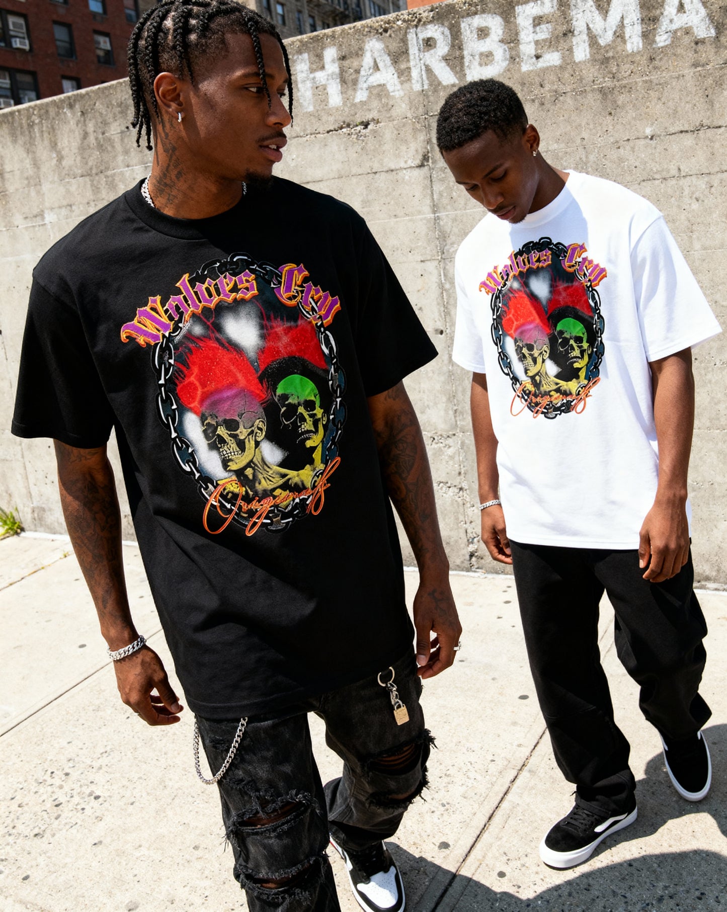 Two models wearing Wolves Cry Megadeath Tee in black and white, styled with red shorts and sneakers — a nod to 90s street energy and Wolves Cry’s vintage athletic roots.