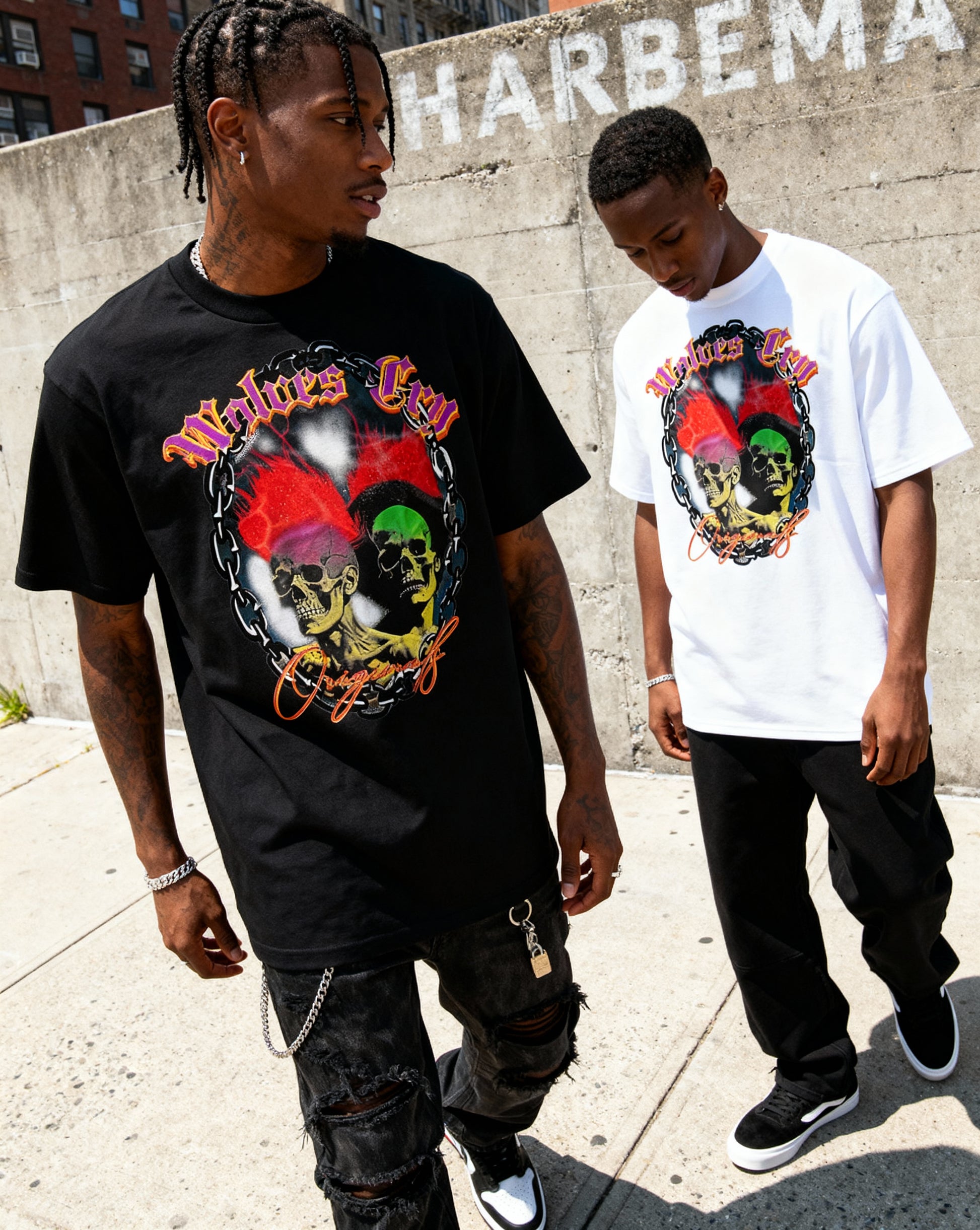 Two models wearing Wolves Cry Megadeath Tee in black and white, styled with red shorts and sneakers — a nod to 90s street energy and Wolves Cry’s vintage athletic roots.