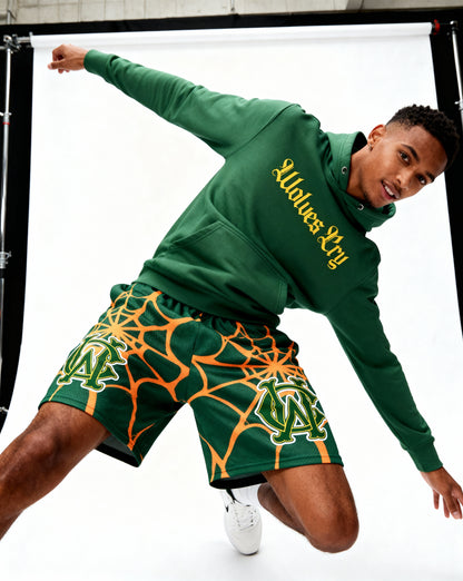 Model wearing Wolves Cry OG Green & Gold Spider Web mesh shorts — relaxed fit, movement-ready street athletic style.