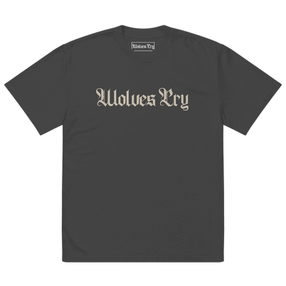 Front view of Wolves Cry Oversized Vintage Wash Tee in black with cream camo spell-out logo — classic, worn-in street uniform energy.
