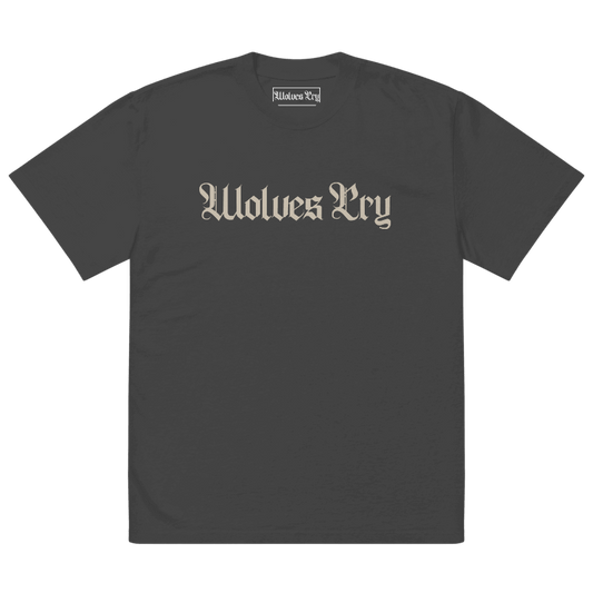Front view of Wolves Cry Oversized Vintage Wash Tee in black with cream camo spell-out logo — classic, worn-in street uniform energy.