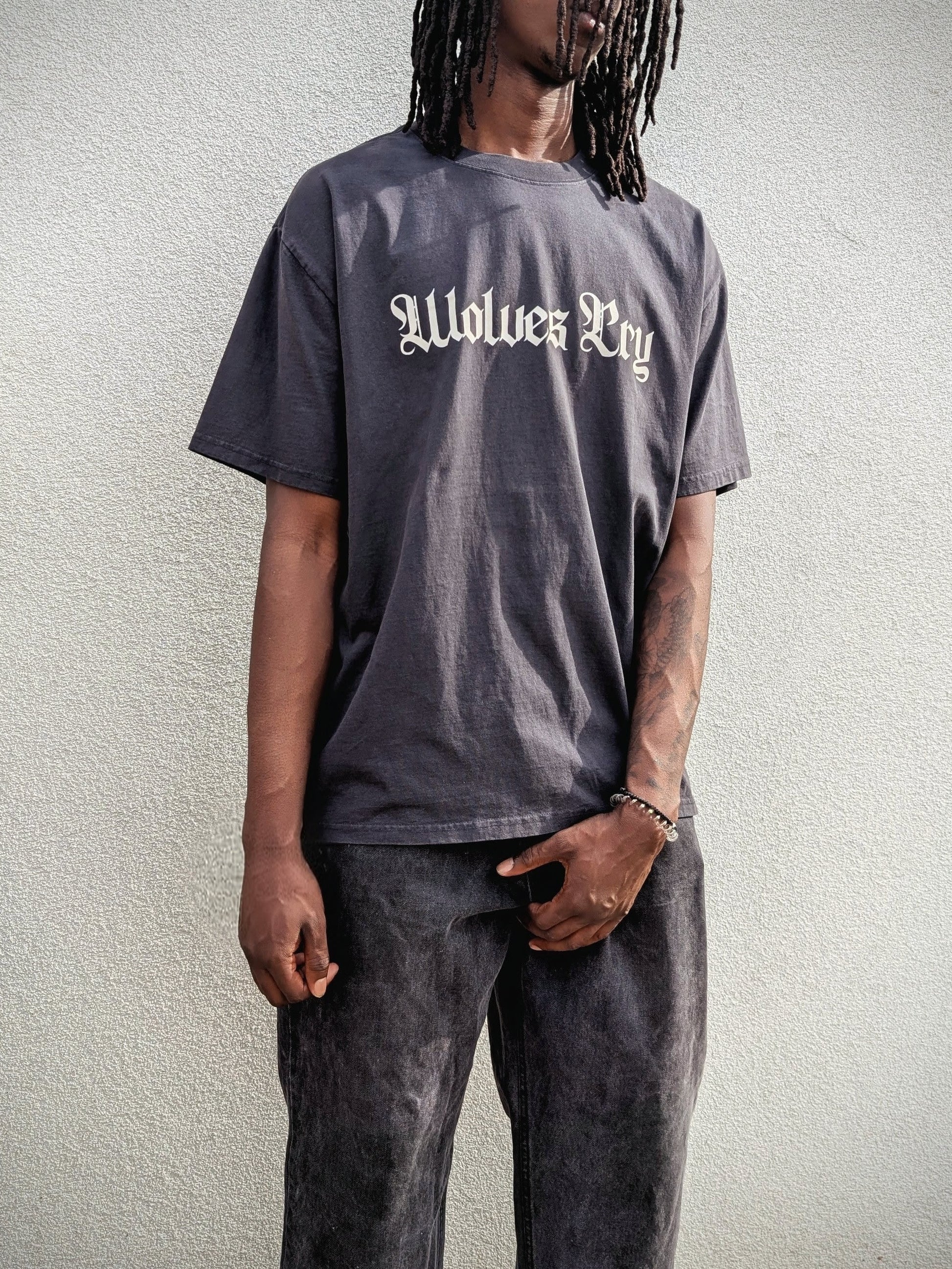 Model wearing Wolves Cry Oversized Black Vintage Tee with cream spell-out — relaxed drape, rugged texture, everyday vintage statement.