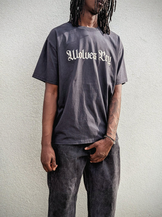 Model wearing Wolves Cry Oversized Black Vintage Tee with cream spell-out — relaxed drape, rugged texture, everyday vintage statement.